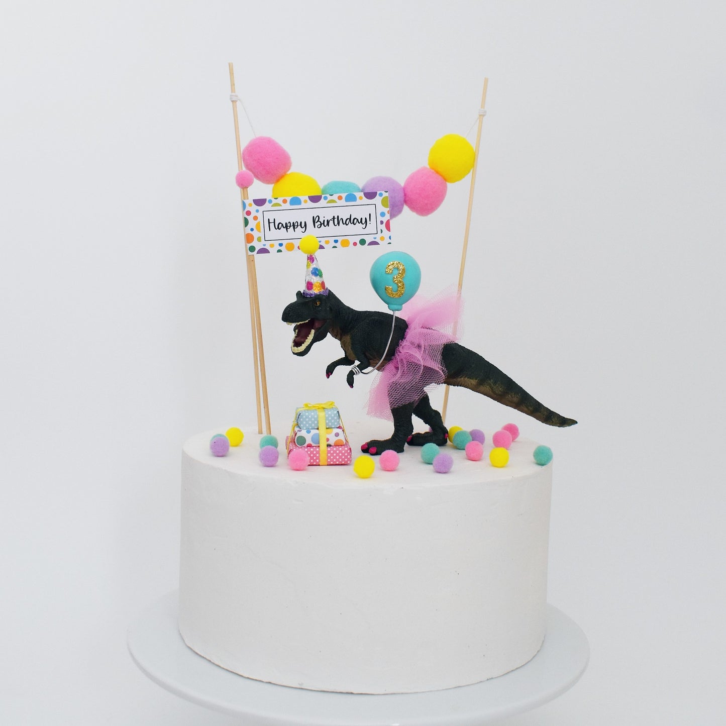 bright rainbow dinosaur cake topper