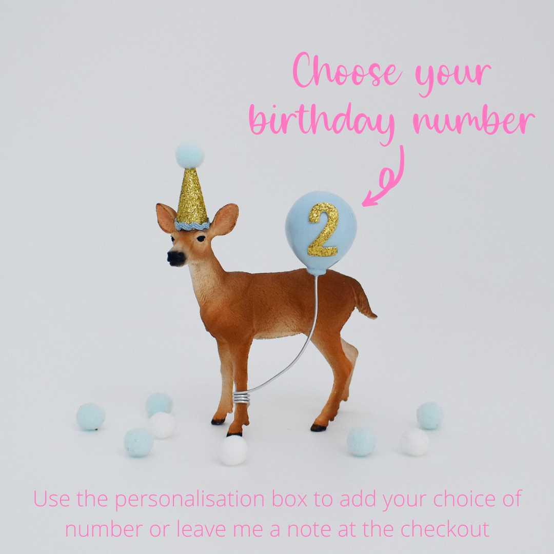 blue deer with party hat cake topper