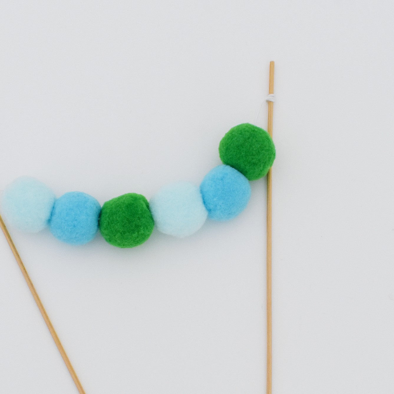 blue green pom pom cake bunting