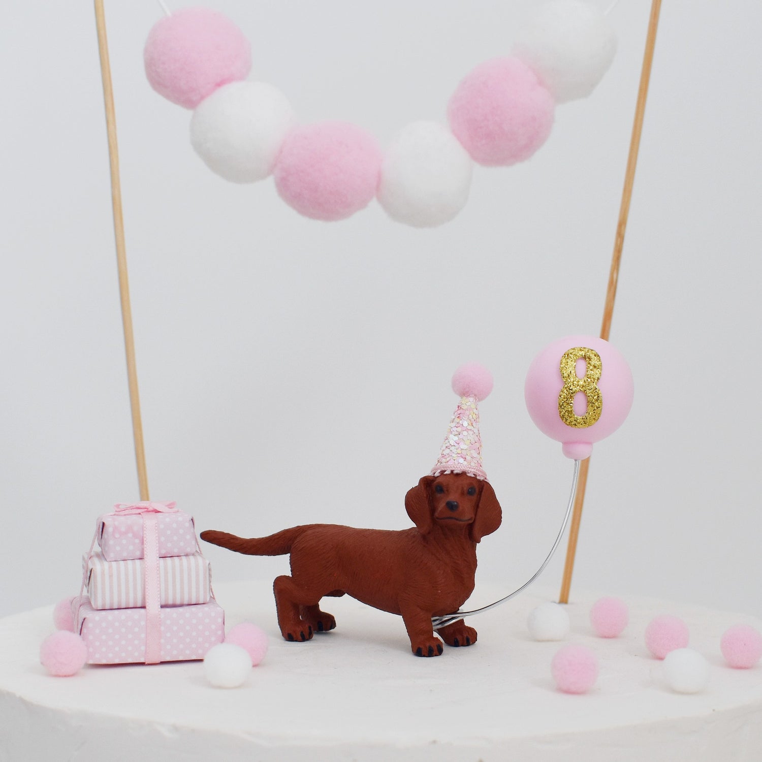 pink dog with party hat and balloon cake topper
