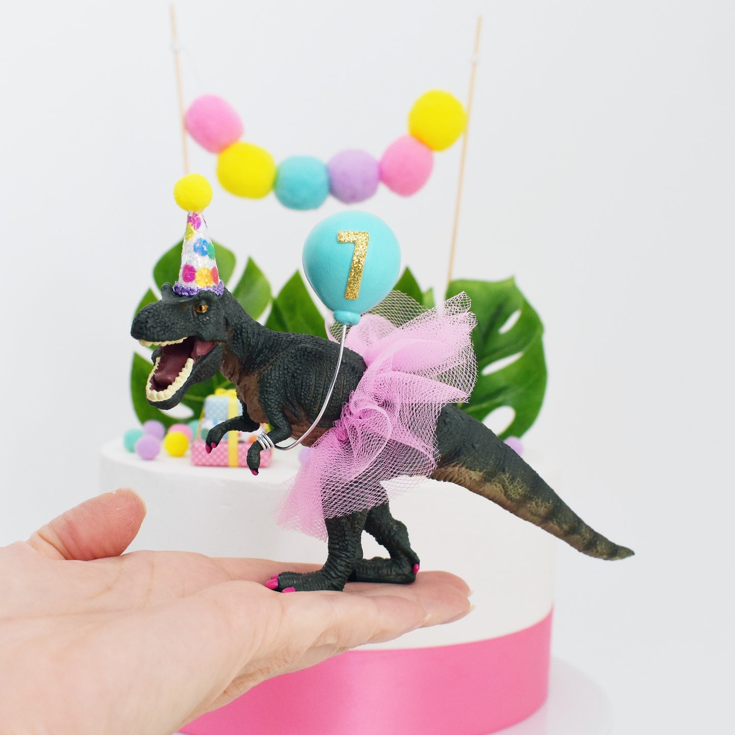 rainbow dinosaur cake topper with party hat and tutu