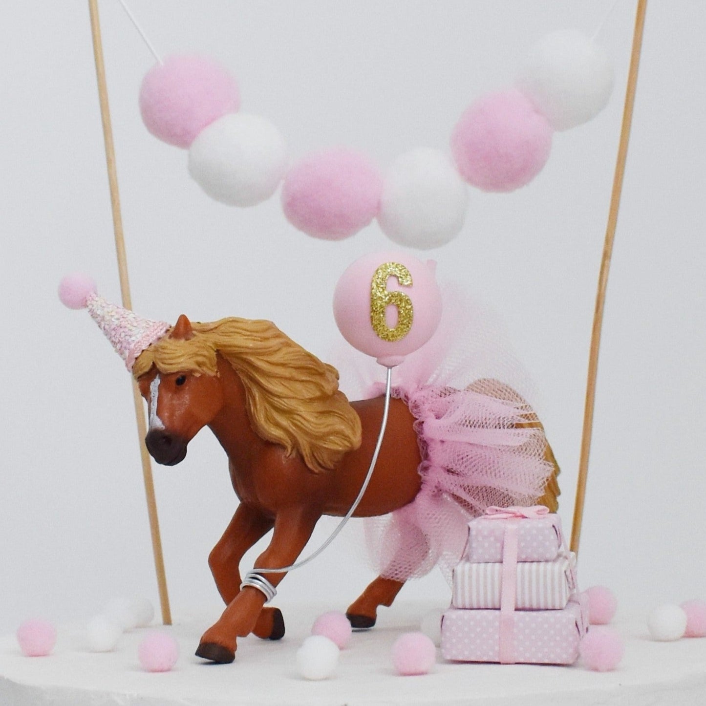 pink horse cake topper with party hat