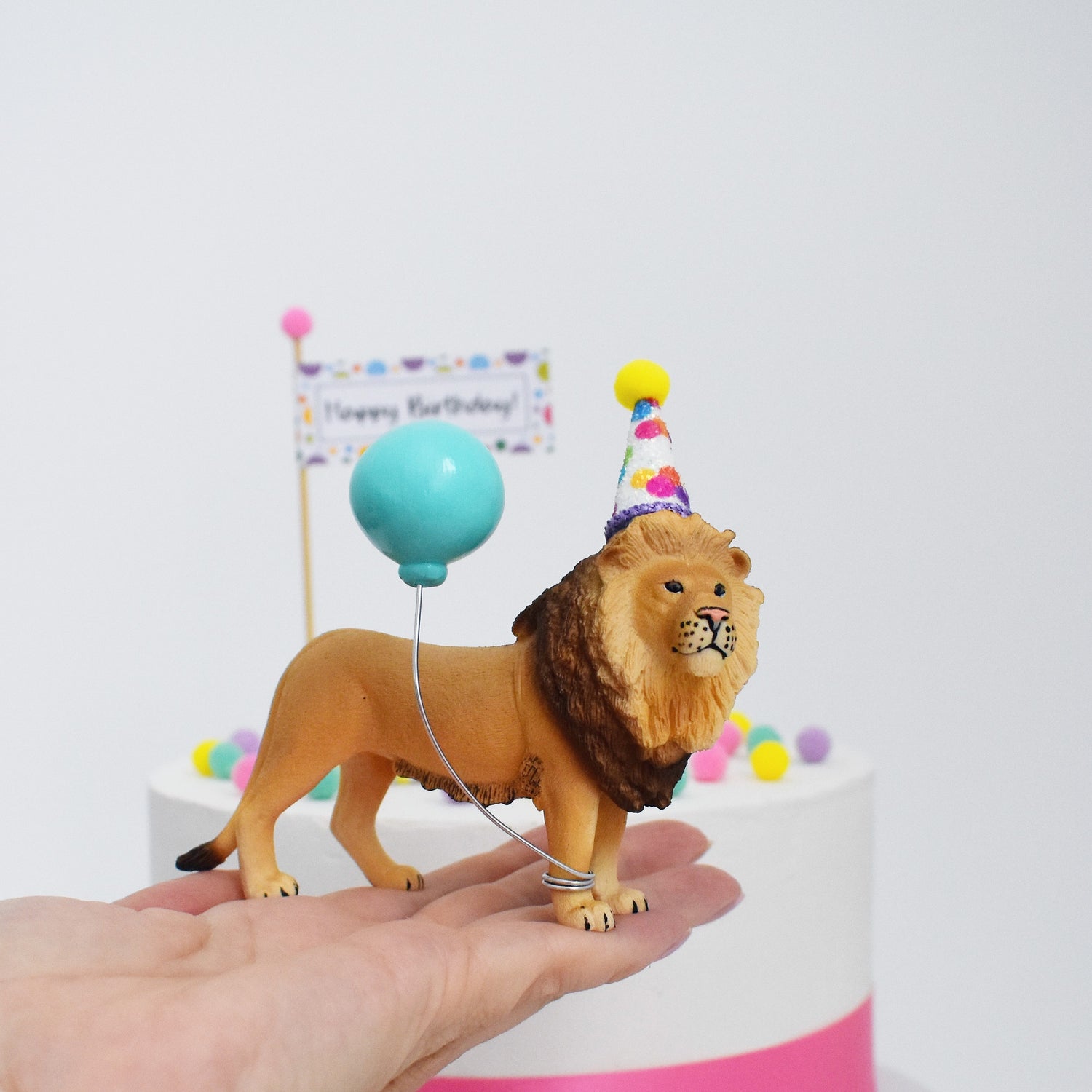 lion with party hat and balloon cake decoration