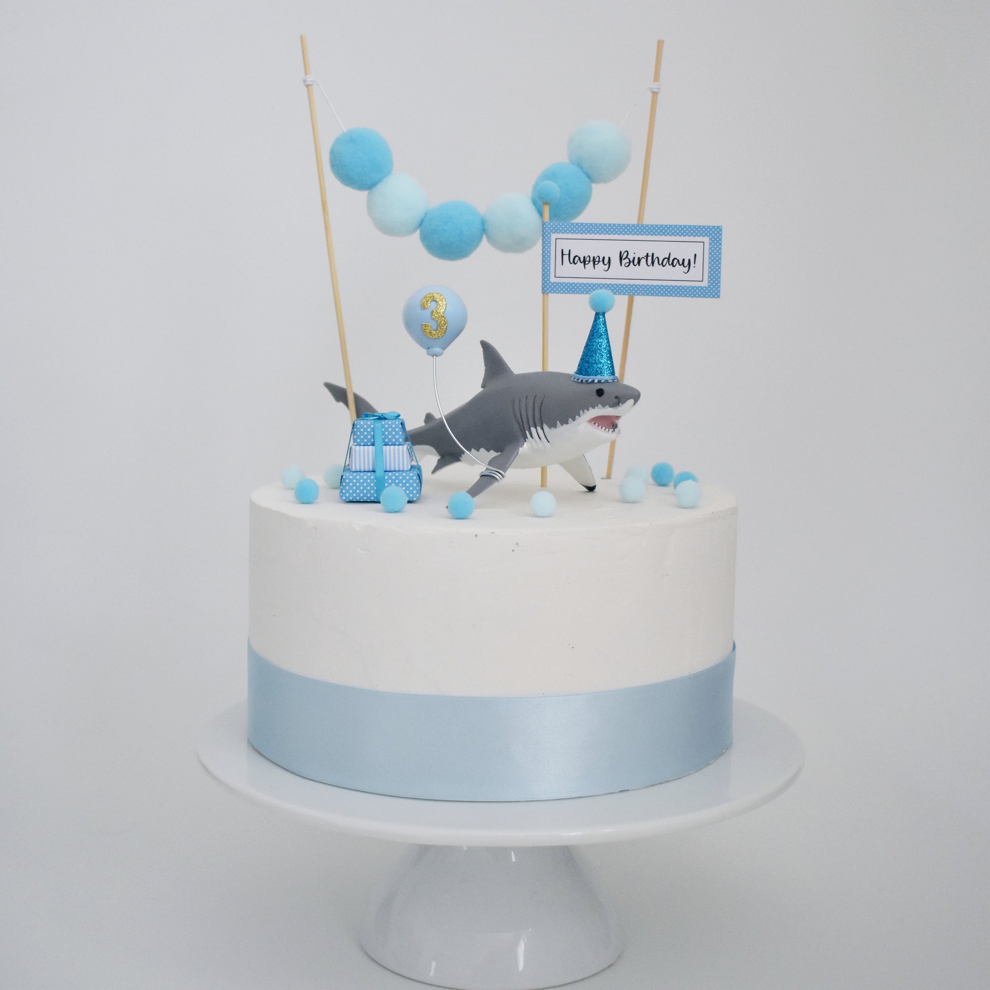 shark themed birthday cake with party hat