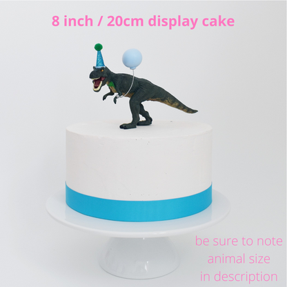 dinosaur with party hat cake decoration
