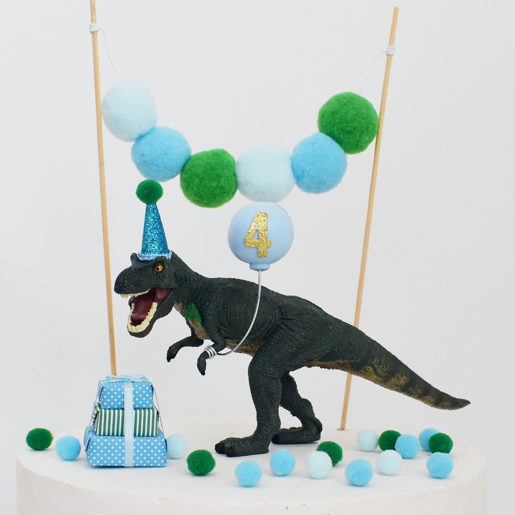 blue green dinosaur with party hat