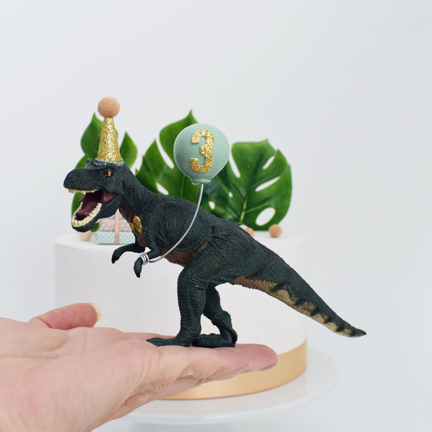 dinosaur with party hat and balloon decoration