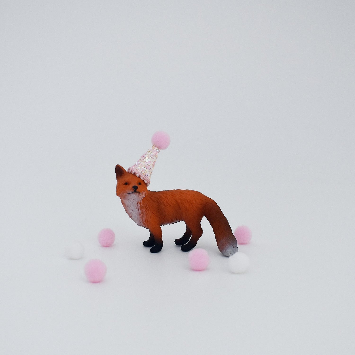 pink fox with party hat cake topper