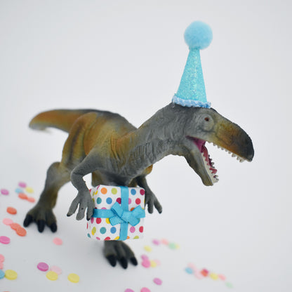 dinosaur with blue party hat