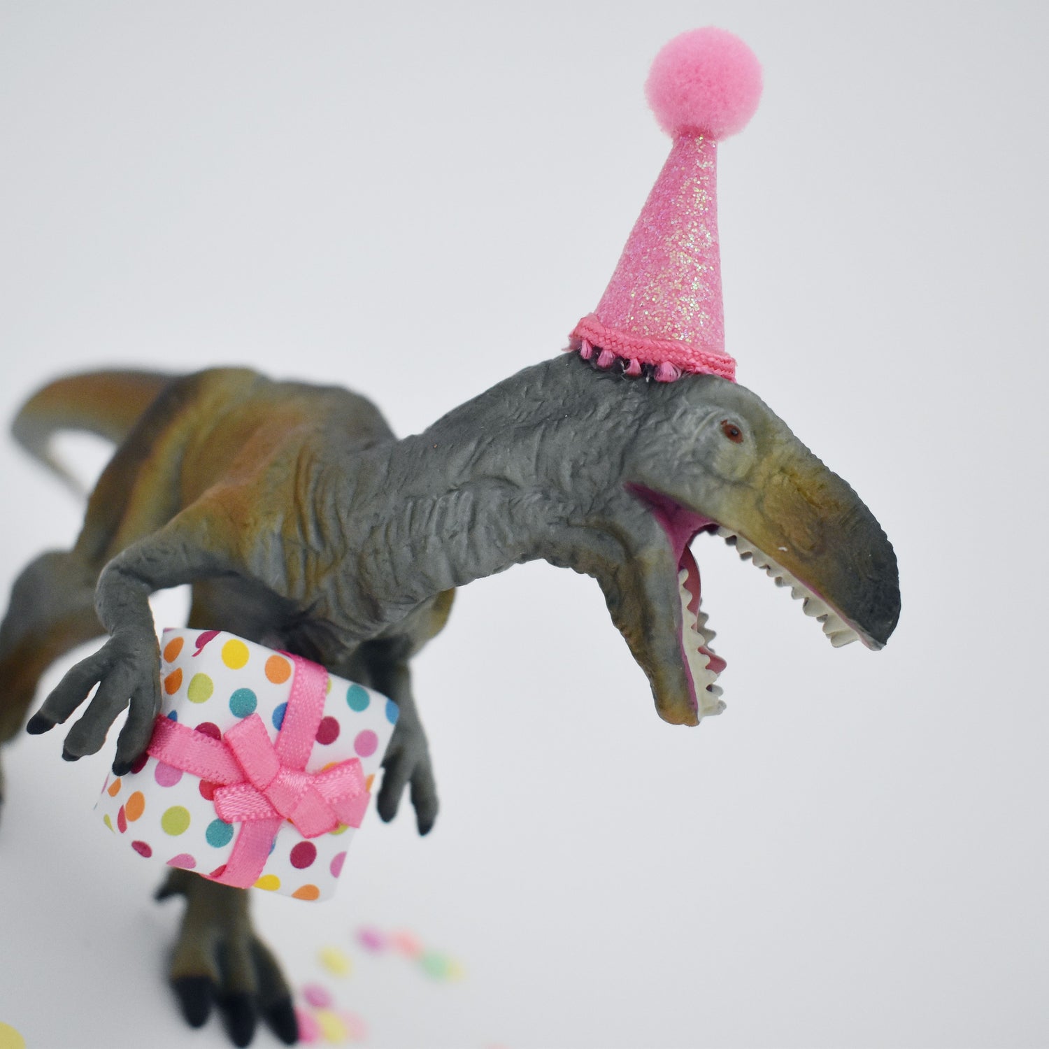dinosaur with pink party hat