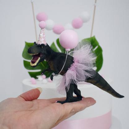 dinosaur with pink tutu and party hat